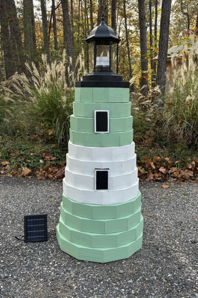 5 ft. lighthouse painted green and white