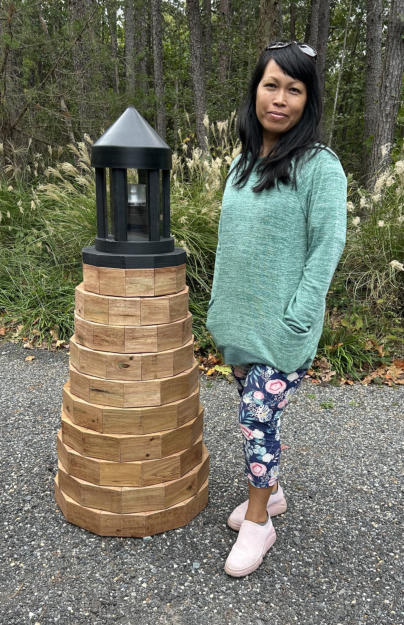 woman standing next to lighthouse